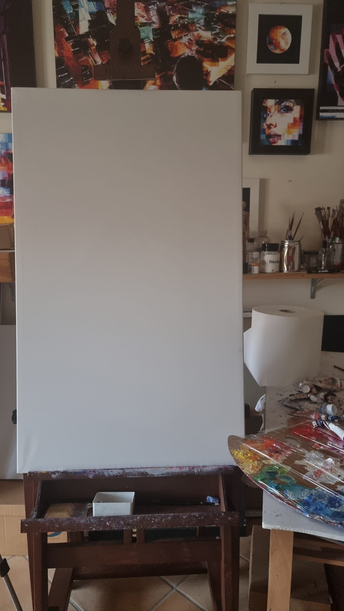 An artist's studio with a blank white canvas on an easel, surrounded by colorful paint tubes, brushes, and a palette filled with vibrant colors. The empty canvas symbolizes potential, stillness, and the starting point of a creative journey, as described in the blog about transforming inner void into energy through art.