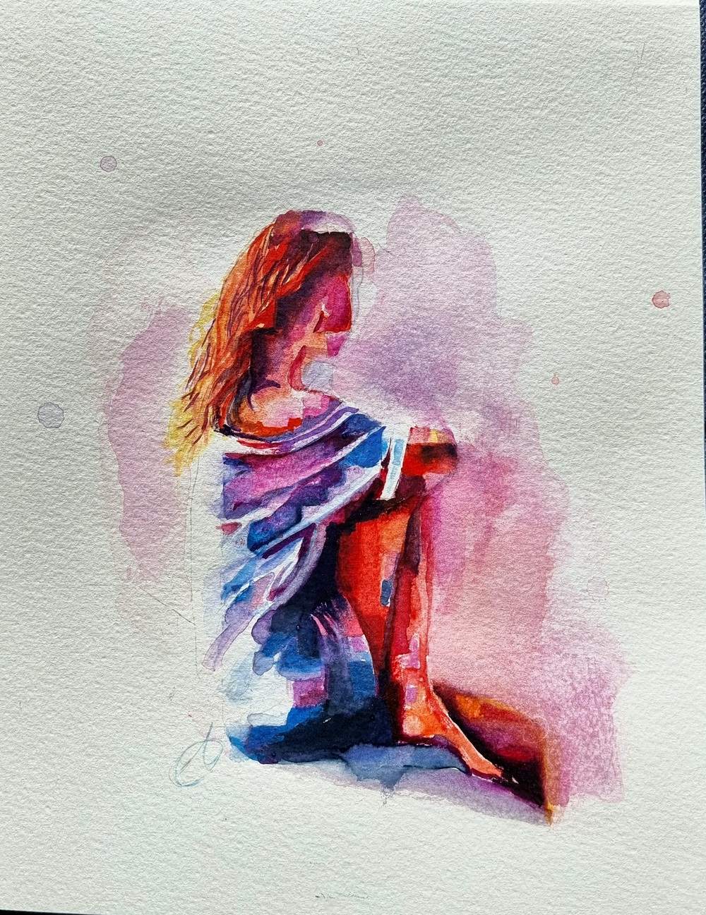 Watercolor painting of a seated woman, seen from behind, wrapped in a loose garment with warm red and blue tones. Soft background blending into abstract hues.