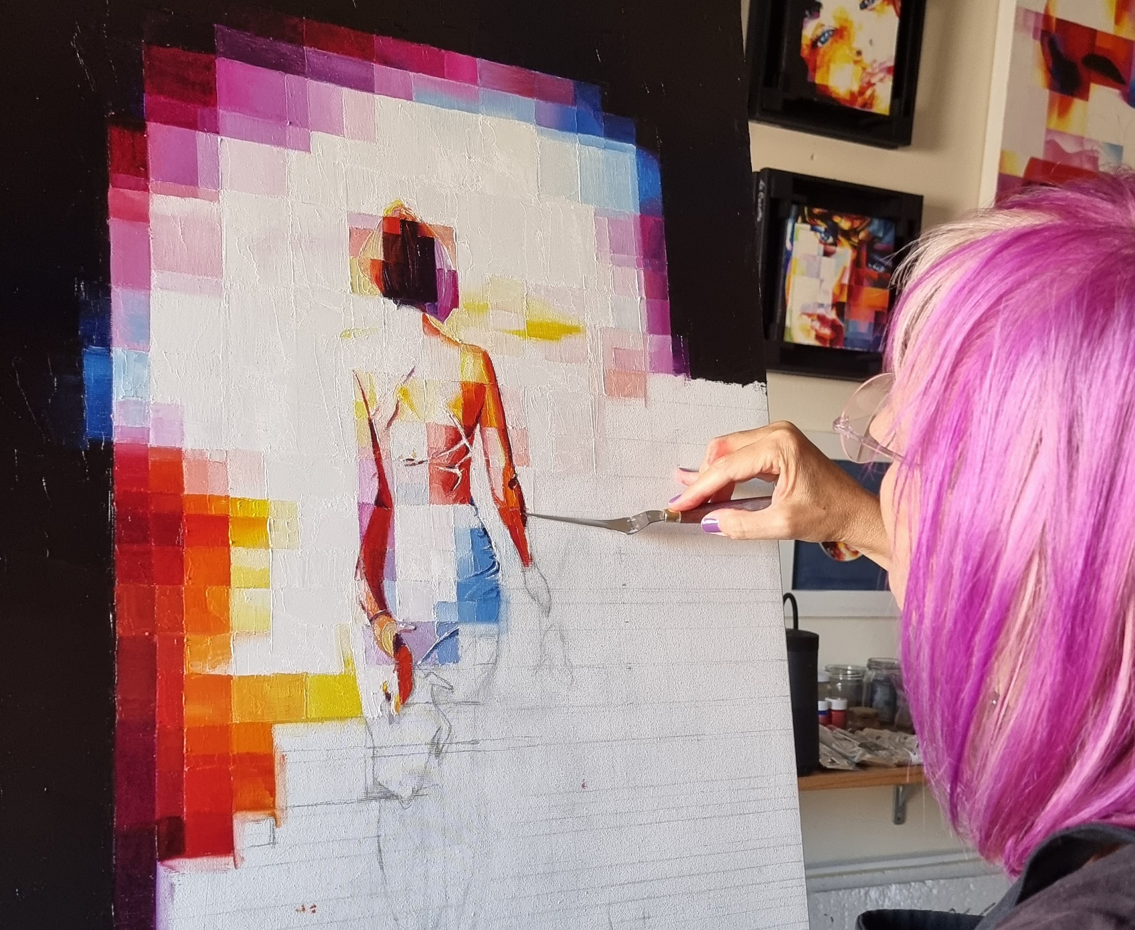 A Touch of Magenta in My Hair Portrait of the artist with magenta highlights in her hair, beside a canvas in her studio.