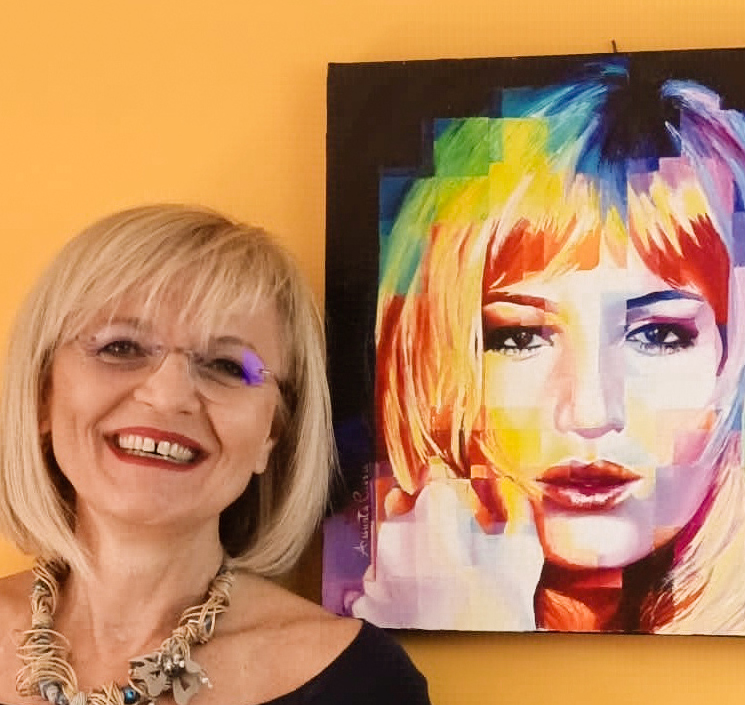 Assunta Cassa beside her painting of Monica Vitti, a colourful contemporary portrait composed of fragmented forms.